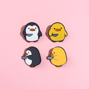 Set of four cute penguin and duck enamel pins holding knives on pink background