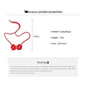 Detail view of red knitted flower necklace with pearls showing dimensions 104x4.5cm