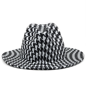 Close-up of classic black and white houndstooth pattern texture on the wool felt fedora hat