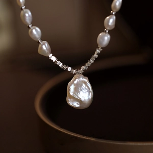 Macro shot of baroque pearl necklace with irregular pearls and silver metal spacer beads