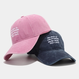 Pink and navy washed cotton baseball caps with embroidered You Need To Calm Down slogan