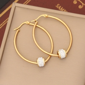 Detail of gold hoop earrings featuring a movable bead with pavé sparkling crystals