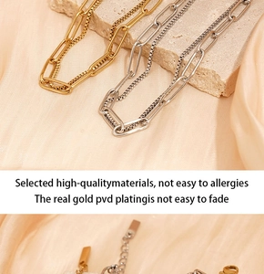 Detailed close-up of gold and silver double-layered titanium steel bracelets on silk
