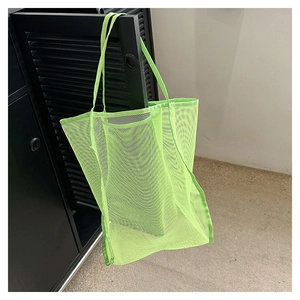 Close-up of a neon green mesh tote bag showing breathable texture and durable handles