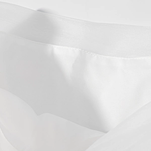 Detailed macro view of white translucent organza fabric texture and fine stitching