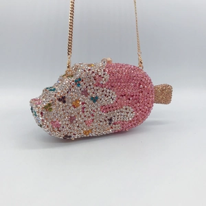 Detail showing the colorful crystals and golden chain of the popsicle-shaped evening bag