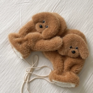 Detailed close-up of brown teddy dog plush gloves with thick fleece lining and white cord