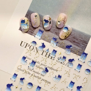 3D embossed nail art stickers with planet and cartoon animal patterns in blue and gold