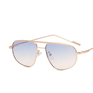 Classic aviator sunglasses with gold metal frame and blue to brown gradient lenses