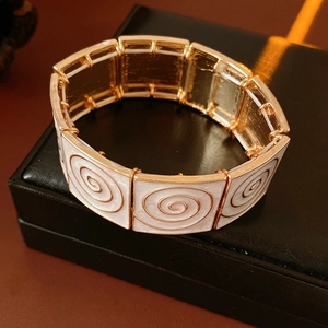 Detail of vintage enamel rectangle panel bracelet with spiral texture on black leather box