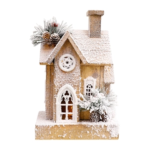 Lighted wooden Christmas house with artificial snow and pine cones for festive decoration