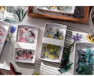 Detailed macro view of 40pcs PET floral stickers in retro boxes for scrapbooking decor