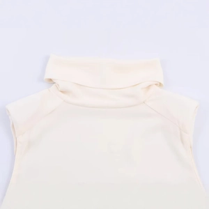 Chic cream-colored sleeveless turtleneck top featuring fringed padded shoulder details