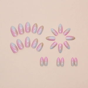 Rainbow gradient press-on nails with lace patterns and glitter finish on pink background