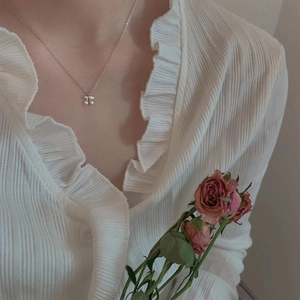 Cute cherry pendant necklace with pearls on a silver chain worn by a female model