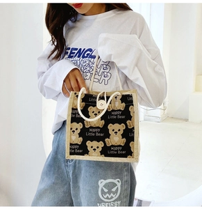 Detail of cartoon bear canvas tote bag with cotton rope handles and button closure