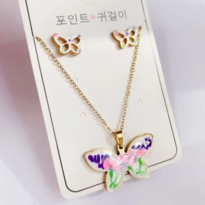 Macro view of golden butterfly jewelry set with colorful enamel wings and artistic details