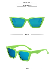 Close-up of neon green cat-eye sunglasses with blue reflective lenses and metal rivets