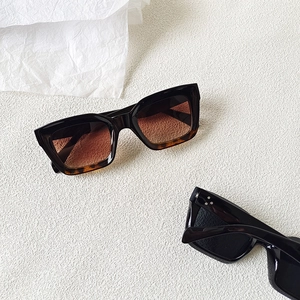 Retro oversized sunglasses in black and tortoiseshell finish with metal stud accents