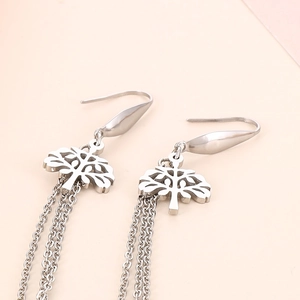 Detail of silver tree of life earrings with cascading long metal fringe chains