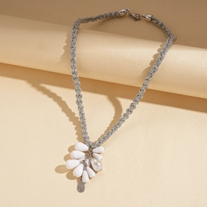 Detail of silver woven chain necklace with white acrylic teardrop pendant clusters