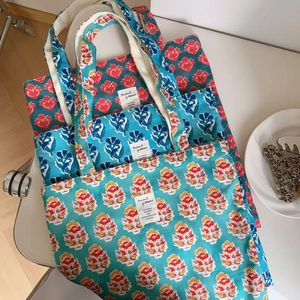 Detailed view of three vintage Indian print cotton tote bags with floral patterns