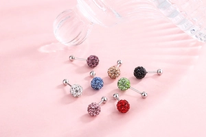 Detailed macro shot of colorful rhinestone ball earrings with various color options
