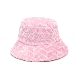 Detail showing plush pink bucket hat with distinctive V-shaped quilted texture and soft faux fur