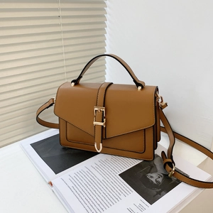 Brown PU leather minimalist flap bag with gold hardware and shoulder strap on magazine