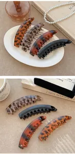Macro detail of French vintage banana hair clips in tortoiseshell and marble patterns