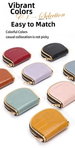 Macro shot of colorful faux crocodile leather purses with gold trim and zipper closure