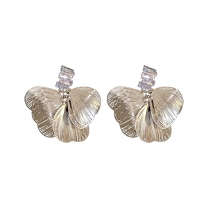Exaggerated silver zircon petal stud earrings with brushed metal texture on white background
