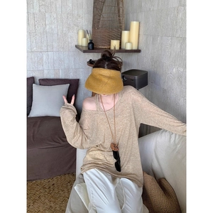 Women's khaki knit off-shoulder long sleeve top paired with a woven straw sun hat