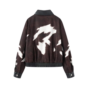Short cow print jacket with black faux leather trim and silver snaps from back view