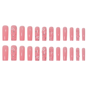 Pink press-on nails in long coffin shape with 3D floral and rhinestone nail art decorations