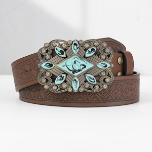 Detail of brown leather belt with embossed floral patterns and turquoise gemstone buckle