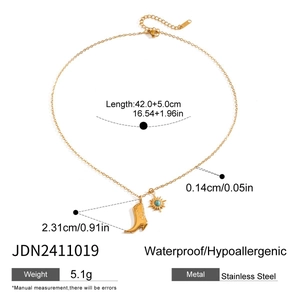 Detail view of stainless steel cowboy boot and sun necklace with precise size measurements