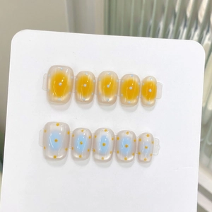 Handmade press-on nails in short round shape with blue and yellow polka dot cat eye design