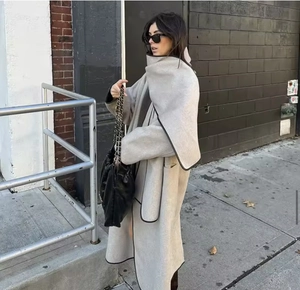 Detail of oat grey wool coat showing the integrated scarf design and fabric texture