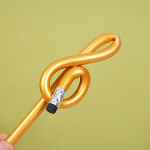 Flexible golden musical note shaped pencil with eraser on a light green background