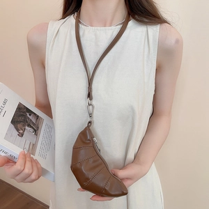 Détail d'un sac tour de cou en forme de croissant en similicuir marron avec fermeture éclair