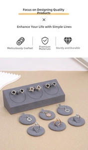 Macro detail of gray microfiber jewelry display stand for rings and earrings