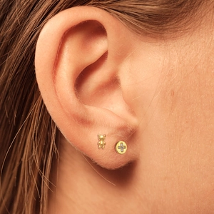 S925 silver golden bear and sparkling cross stud earring set shown on ear earlobe