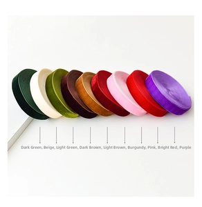 Macro shot of 9-color velvet ribbon rolls for DIY Christmas gift wrapping and decor