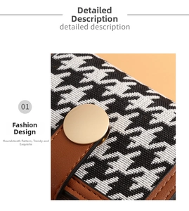 Close-up of houndstooth fabric with brown leather trim and matte gold metal button clasp