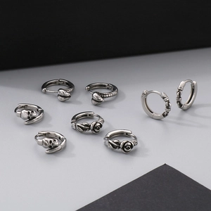 Vintage stainless steel earring set featuring snake, skull and rose designs in silver