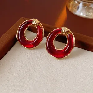 Retro circular hollow resin stud earrings with golden alloy base and water ripple texture