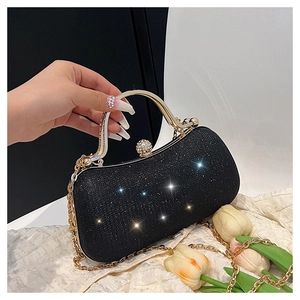 Close-up of black glitter evening clutch featuring gold handle and rhinestone lock detail