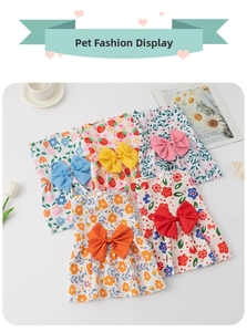 Flat lay of five lightweight summer pet dresses with floral prints and matching large bows