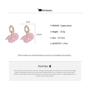 Detailed spec view of pink acrylic flower earrings with zircon knots and silver needles